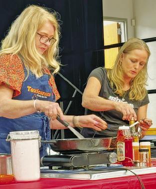 CINDY WILLIAMS, “Texicurean” -- inspired by her passion for Texas food and hospitality, and Shelly Spivey make Sam Houston’s barbecue sauce. Williams held a cooking presentation last Tuesday night in honor of the county’s annual Heritage Week.