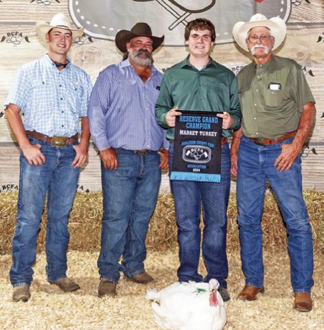 THE RESERVE GRAND Champion Market Turkey winner was Brycen Suehs. Also pictured are Cameron Suehs, Bradley Suehs and Tommy Tietjen. Photo courtesy of Jeffries Livestock Marketing