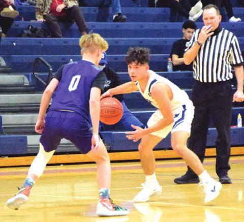 SNOOK’S DAVID DAVILA ATTEMPTS to dribble past an Aggieland HomeSchool player during the Bluejays-Panthers game last Monday night in Snook. -- Tribune photo by Denise Squier-Hornaday