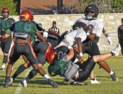 SOMERVILLE’S PETER SALAZAR makes a tackle as teammate Semaj Pennygraph moves in to help. -- Tribune photo by Roy Sanders