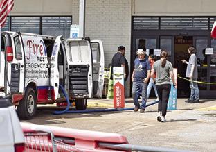 BROOKSHIRE BROTHERS employees greet customers at the store front entrance on Saturday, July 26, in Caldwell.
