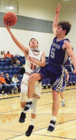 CALDWELL’S LANCE LARA is fouled by a Florence player during Caldwell’s 77-25 win last Friday. -- Tribune photo by Denise Squier