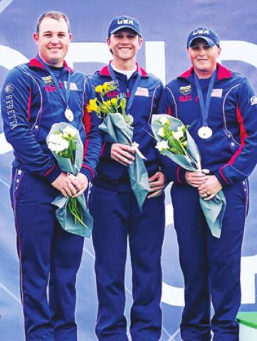 PHILLIP JUNGMAN, left, stands with his teammates, Colt McBee and Hayden Stewart, as they receive their silver medals from competing in the Men’s Skeet Team competition at the World Cup in Cypress last week.