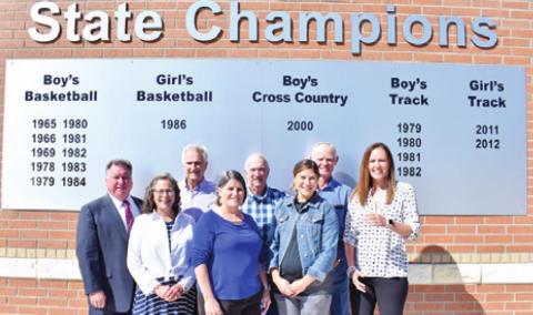 SNOOK RECOGNIZES ITS state champions with this sign. Pictured are, front row, from left, Dana Yezak, Snook Superintendent Brenda Krchnak, and Megan Simank; back row, Donnie Victorick, Jimmy Horn, Don Horn and Melvin Schoeneman.