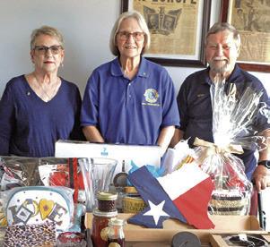 CALDWELL BURLESON County Lions Club members Kathy Cornett, Pat Drouilhet and Adrien Drouilhet III are pictured with some of the auction items for the Denim, Dinner and Dancing Gala. See story inside. Tribune photo by Denise Squier