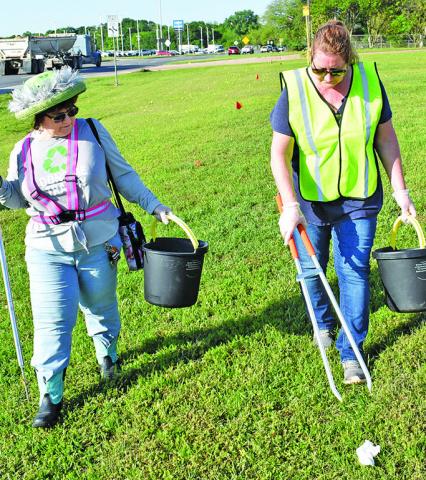 KATHY POLLOCK AND Raileen Murray pick up debris on Saturday morning, April 12, as part of the Keep Burleson County Beautiful Spring Clean Trash Off on State Highway 21 East in Caldwell.