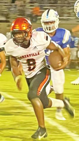 DEVEN GREEN of the Somerville Yeguas breaks away from this Hempstead defender last Friday. -- Photo by Ursula Idlebird.