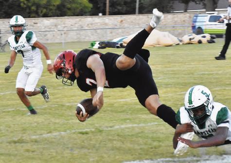 QUARTERBACK IAN Teague is pulled down by this Hempstead defender. The Yeguas won 21-14. Tribune photo by Roy Sanders