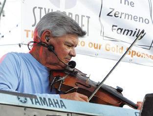 FIDDLES AND keyboards were featured during the Summer Concert Series performance by Texas Unlimited Band (TUB).