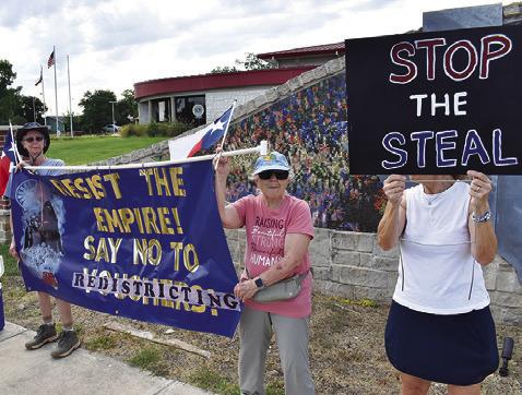 PROTESTERS HOLD THESE signs on Saturday morning in front of the Caldwell Civic Center.