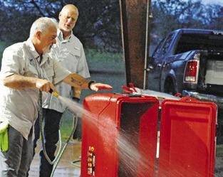 PETE GLIDEWELL CLEANS out this ice chest during Saturday’s shrimp and crawfish dinner fundraiser for Cops4Kids. Tribune photo by Denise Squier