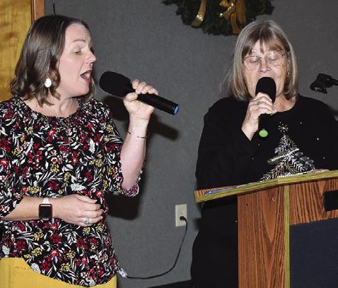 JENNIFER HUBER AND Gayla Townsend sing on Saturday, Dec. 6, at the First United Methodist Church Angel Tea.