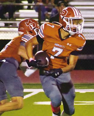 E.J. ROGERS carries the ball for Caldwell against Giddings last Friday.