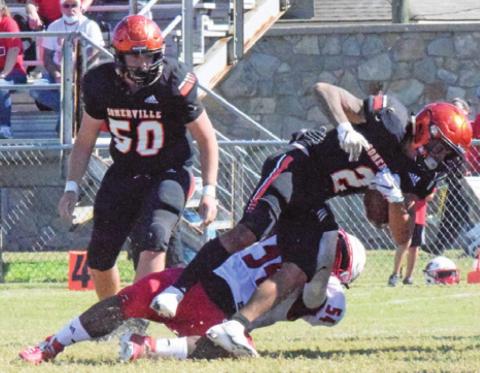 SOMERVILLE’S JEREMIAH TEAGUE is tackled by a Burton defender during the Yegua’s last game of the season on Saturday. Also pictured is Ross Dubois for Somerville. -- Tribune photo by Miranda Jones