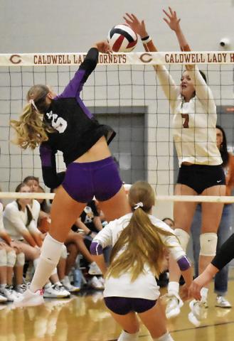 CALDWELL’S CLOEY RUSS attempts to block a spike from Thrall’s Brenna Tucek during the Lady Hornets’ match against Thrall on Friday at Hornet Gym. See story inside for more about the match. Tribune photo by Roy Sanders