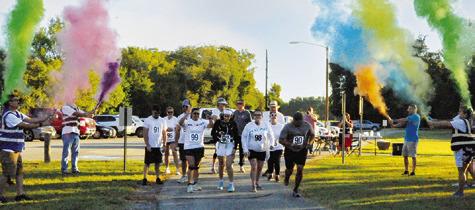 RUNNERS AND WALKERS WERE SHOWERED with color at the start