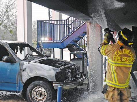 A CALDWELL FIREFIGHTER sprays water on the walls at Roadway Inn at this truck fire on Monday, March 4, in Caldwell.