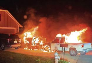 FIRE ENGULFS THESE pickups on Meadow Brook Drive.