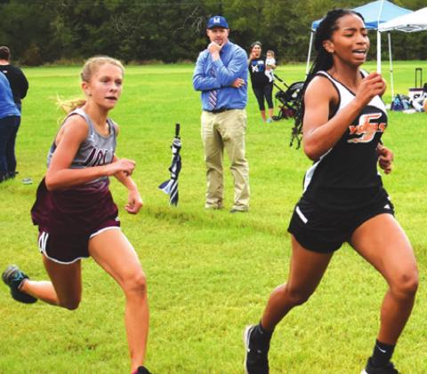 SOMERVILLE’S RA’MAYA CARTER pushes herself to finish seventh in the varsity girls’ division at the District 26-2A Cross Country Meet and qualify for the regional meet. -- Tribune photo by Roy Sanders