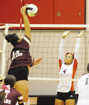 SOMERVILLE’S GABBY JACKSON prepares to attempt to block a hit from a Milano player during the Lady Yegua-Lady Eagle match last Friday in Somerville. -- Tribune photo by Denise Squier