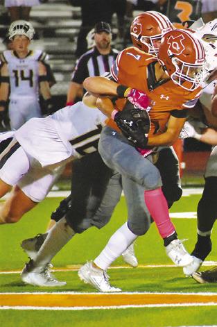 E.J. ROGERS fights through this Giddings defender for yardage last Friday in Caldwell. -- Tribune photo by Roy Sanders