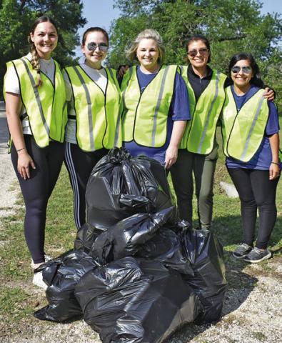 THIS CITIZENS STATE Bank crew works early Saturday, May 10, at the Burleson County Spring Clean Trash Off along County Road 409. They include, from left, Kendra Wiatrek, Savannah Zuniga, Melanie Schulte, Norma Medina and Veronica Castillo.