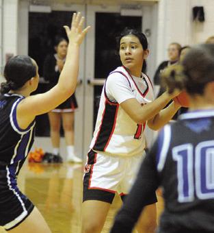 ANETTE REYNA looks for help from a teammate during the Somerville-Mumford game last Friday night at the Yegua Gym. Tribune photo by Denise Squier