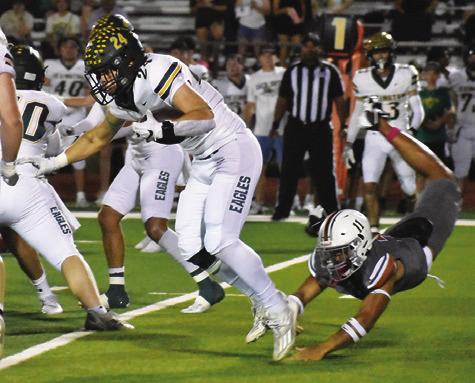 CALDWELL’S ZANE BROWN dives at this Lexington ball carrier. Tribune photo by Roy Sanders