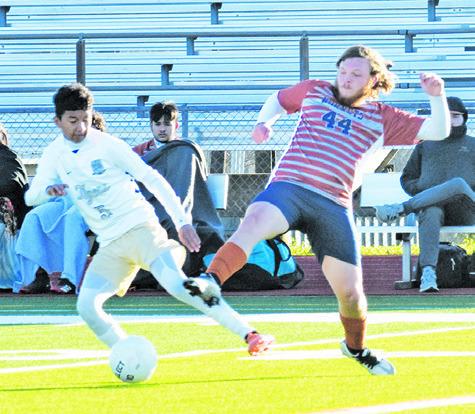 CALDWELL’S ERLING CASCO fights for possession of the ball during the Caldwell-Rockdale district game last Friday. -- Tribune photo by Roy Sanders
