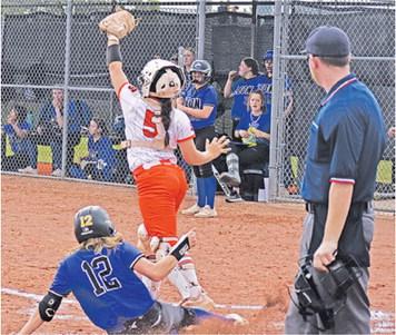 SOMERVILLE’S AVERIE HERNANDEZ catches the ball while a Leon runner slides into home plate last Friday during the Somerville-Leon bi-district game.