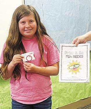 ALLY WRIGHT completed her 100-page math packet from First Baptist School’s summer program.