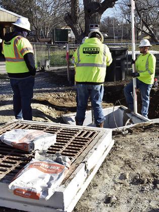 A CONSTRUCTION CREW works on drainage on Friday, Jan. 16, at F.M. 975 in Caldwell. TxDOT is rebuilding the road.