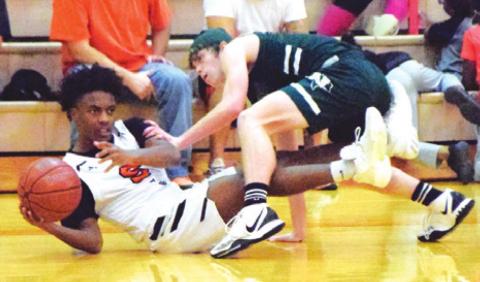 SOMERVILLE’S VERKOBE WOODBERRY fights Normangee’s Nicholas Childress for possession of the ball during the Yeguas’ 59-45 loss to Normangee last Tuesday night. -- Tribune photo by Denise Squier AAAAAAA JOHNNY LEGG tries to shoot the ball while being double-teamed by the Normangee defense. --- Tribune photo by Denise Squier