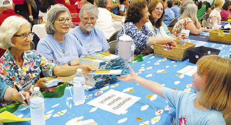 THE DEANVILLE HERITAGE Foundation gave Burleson County students boxes of pencils at Monday’s “Back-to-School Blast” at the Burleson County Expo Center. Tribune photo by Denise Squier