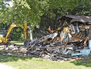 THE OLD BUILDING is demolished at 203 N. Main Street in Caldwell at the new site of the Texas Czech Genealogical Society.
