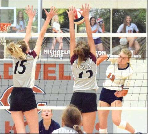 THE LADY HORNET VOLLEYBALL TEAM had a great 2019 season, finishing with a 43-6 record and a regional final berth. The team tops this year’s sports stories for 2019. Pictured is Marley Maurer hitting the ball through an Iola blocker. -- Tribune photo by Denise Hornaday