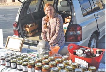 AUDREY GUTKE WORKS on Saturday at the booth for Hope Springs Farm at the weekly farmers market in downtown Caldwell.