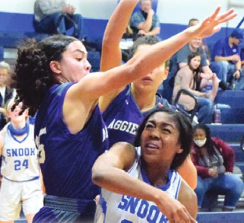 JAIVAN STRINGFELLOW is doubleteamed while trying to shoot during the Snook-Aggieland Home-School game last Monday.