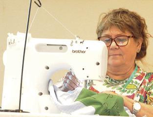 SNOOK EEA MEMBERS hosted a “sew-in” to support The Blessing Box Project, which provides mastectomy pillows and drain shirts for women battling breast cancer. Tribune photo by Denise Squier