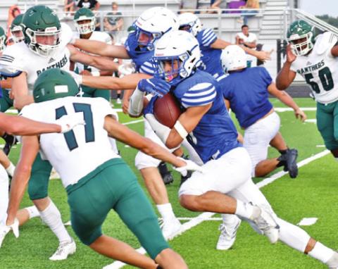 SNOOK’S JOSE GARCIA carries the ball against Normangee in last Friday’s scrimmage in Snook. -- Tribune photo by Roy Sanders