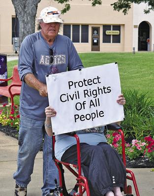 PROTESTERS DISPLAY signs at the No Kings event in Caldwell.