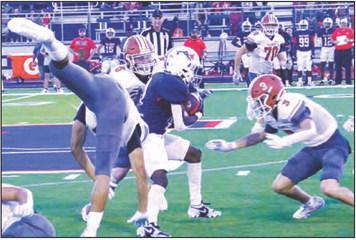 E.J. ROGERS, CORBIN Stewart and Caden Schluens defend against this Madisonville running back. -- Tribune photo by Roy Sanders