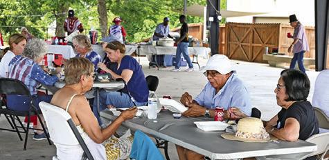 BURLESON COUNTY DEMOCRATS enjoyed a barbecue chicken dinner at their July 4th celebration on Saturday in downtown Caldwell. Tribune photo by Denise Squier