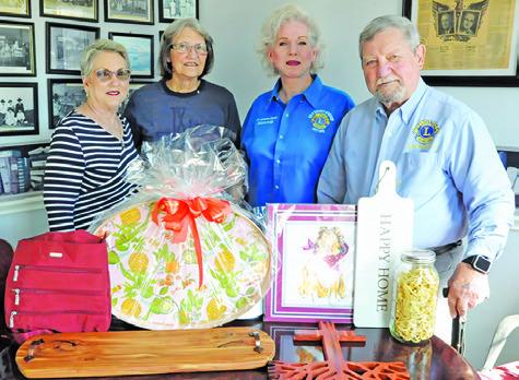 THE CALDWELL BURLESON COUNTY Lions Club is holding its annual Denim, Dinner and Dance gala this Saturday at the Caldwell Civic Center. The items pictured will be sold during auctions at the event. Also pictured are: Kathy Cornett, Immediate Past President and Zone Chairman; Pat Drouilhet, Club Secretary; Dr. Johanna Elliot, Caldwell Burleson County Lions Club President; Adrien Drouilhet, Cabinet Secretary. -- Tribune photo by Denise Squier