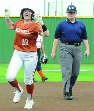 KELLY URBANOVSKY celebrates hitting a home run over the center field wall in the first inning. -- Tribune photo by Denise Squier