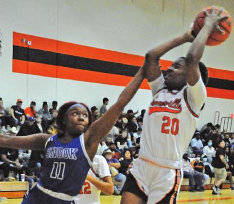 SNOOK’S LABRAYLA POOL reaches to try to keep Somerville’s Camia Martin from scoring during Somerville’s 42-14 win over Snook.