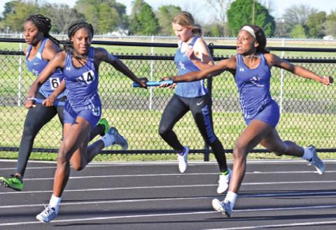 THE LOUIS SISTERS, Bre’Asia and Bre’Anna, compete in a girls’ relay race at the Bluejay Relays last week. -- Tribune photo by Roy Sanders