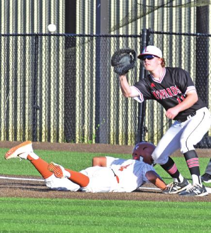KAIN SANCHEZ LUNGES back to first base in time to be safe as the ball approaches. -- Tribune photo by Roy Sanders
