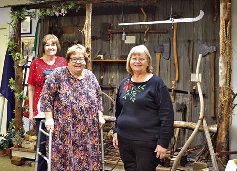 HISTORICAL COMMISSION members Bonnie Blue, Melynda Giesenschlag and Gayla Townsend stand before a museum exhibit during the Burleson County Historical Museum’s open house last Friday in the Burleson County Courthouse. See story inside. Tribune photo by Sabine Lazo