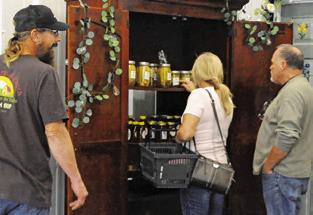 SHOPPERS EXAMINE THE STOREFRONT’S wares at the Boniol Farm and Ranch